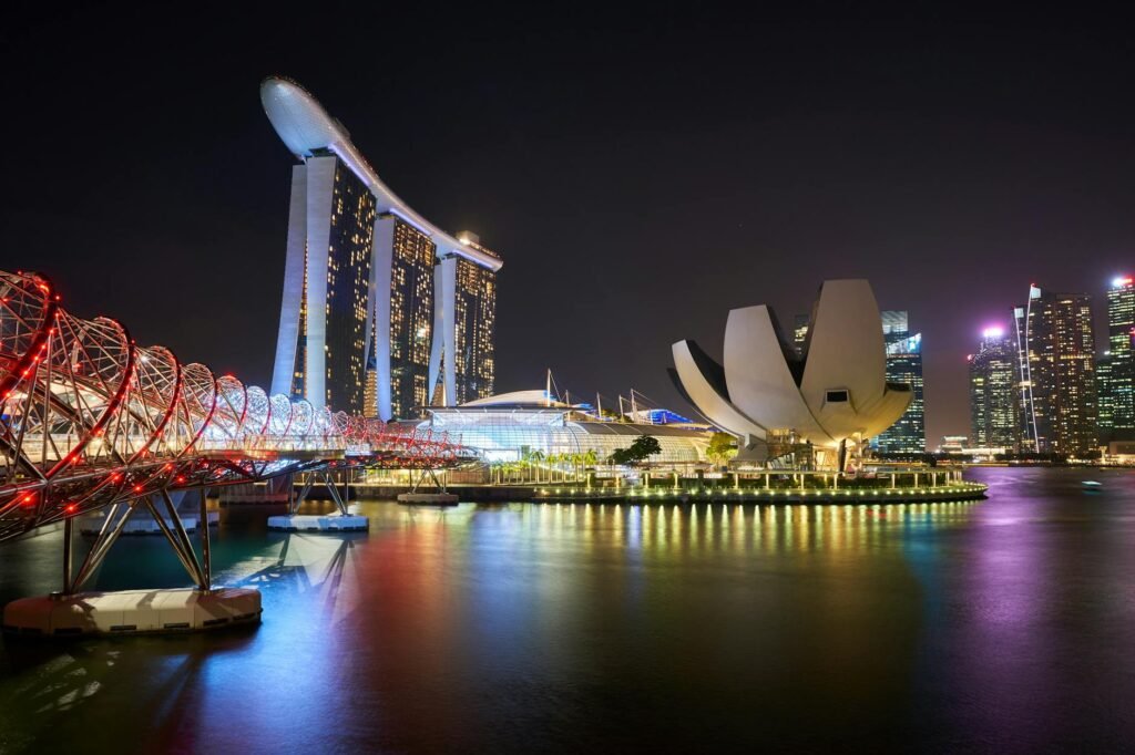 pexels-photo-1842332-1842332 Stunning night view of Marina Bay Sands and Helix Bridge illuminated over water in Singapore.